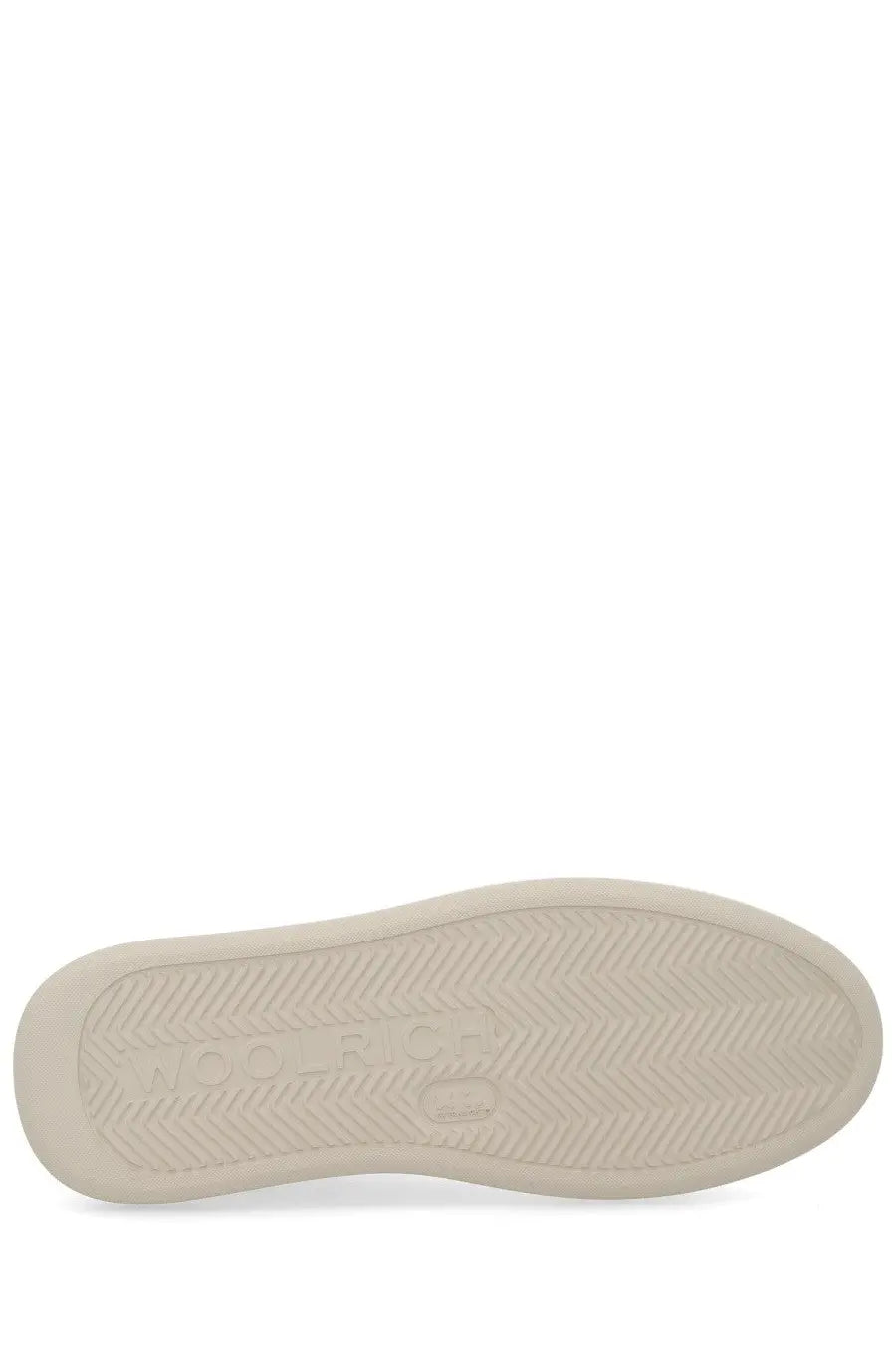 Cream-colored rubber sole with subtle chevron tread and embossed nico branding on woolrich men’s sneaker arrow white