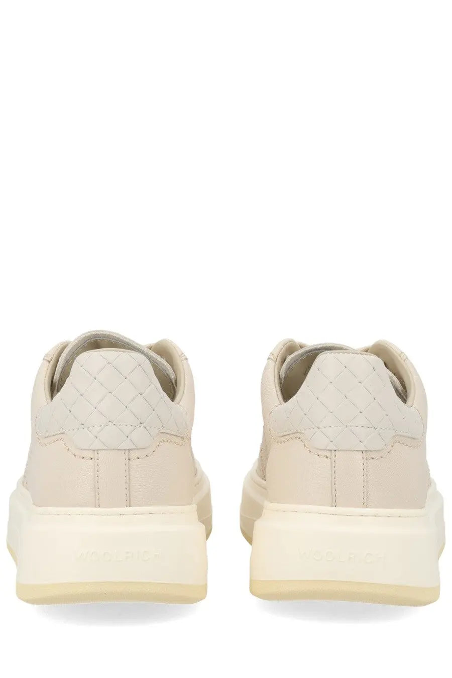 Cream-colored Woolrich women’s leather sneakers with quilted diamond heel and chunky off-white rubber sole back view