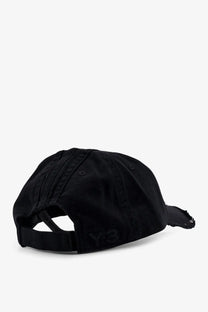 Black y-3 men’s cotton baseball cap showing the back with distressed fabric and faded logo