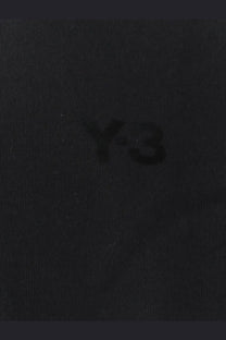 Black y-3 logo embroidered on dark textured fabric of y-3 men’s black cotton sweatshirt close-up