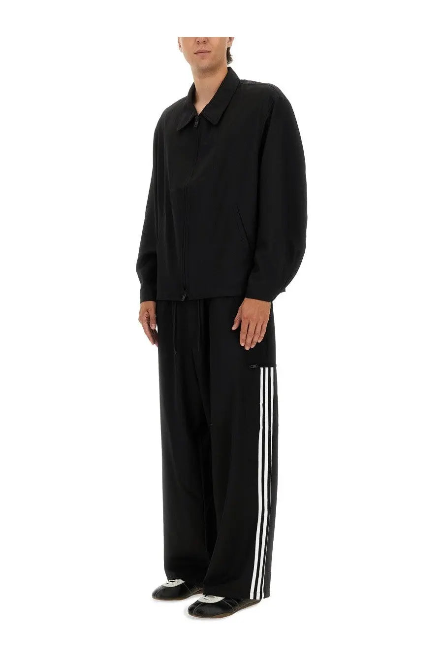 Black adidas y-3 men’s jogger pants with three white stripes down the side in a comfortable track material