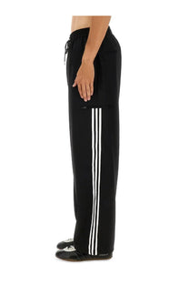 Y-3 men’s jogger pants black featuring three bold white side stripes drawstring waistband and front pockets