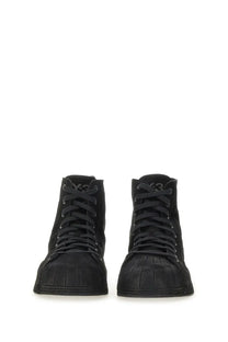 Y-3 men’s nizzastar hi sneaker black featuring black suede high-top design with textured rubber sole and subtle branding on tongue