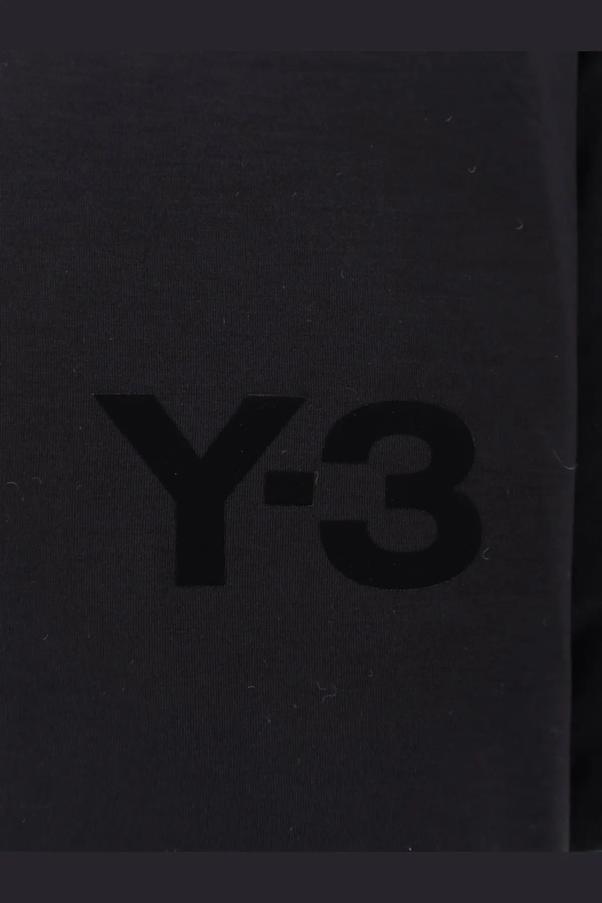 Black y-3 logo printed on textured dark gray surface of y-3 men’s padded jersey sweatshirt black