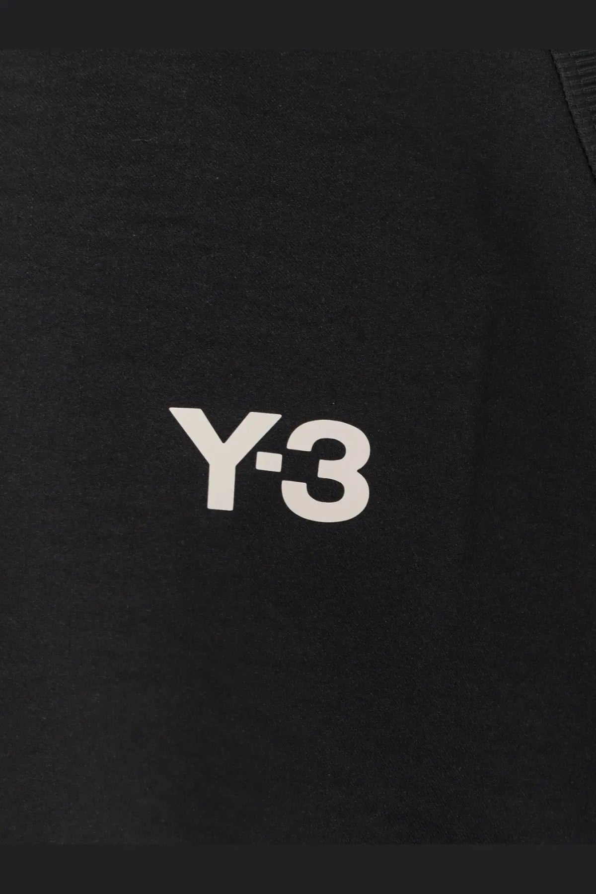 Y-3 men’s black recycled polyester jacket with bold white logo prominently displayed on the chest
