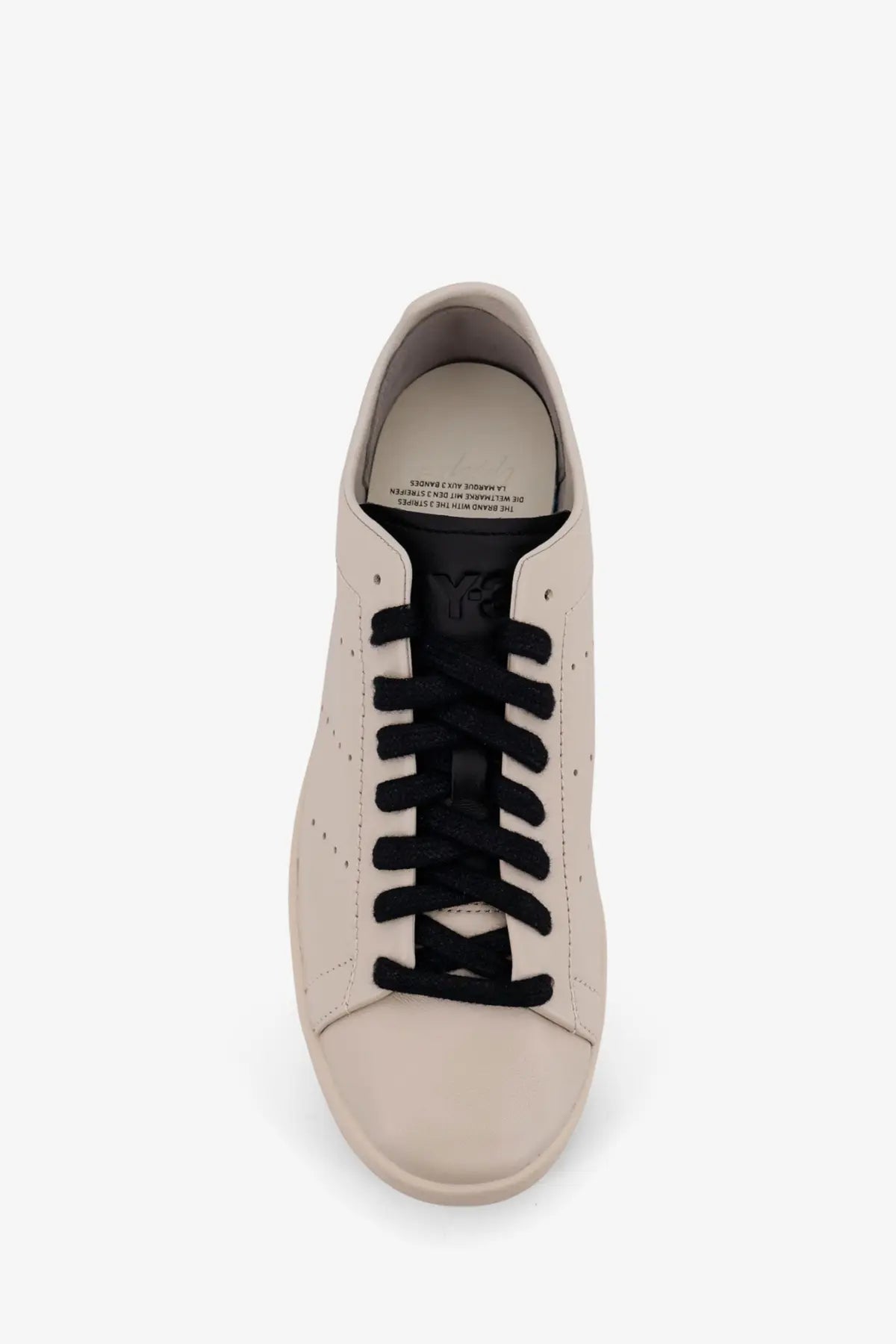 Cream-colored leather low-top y-3 men’s stan smith sneakers with black laces and subtle logo on the tongue