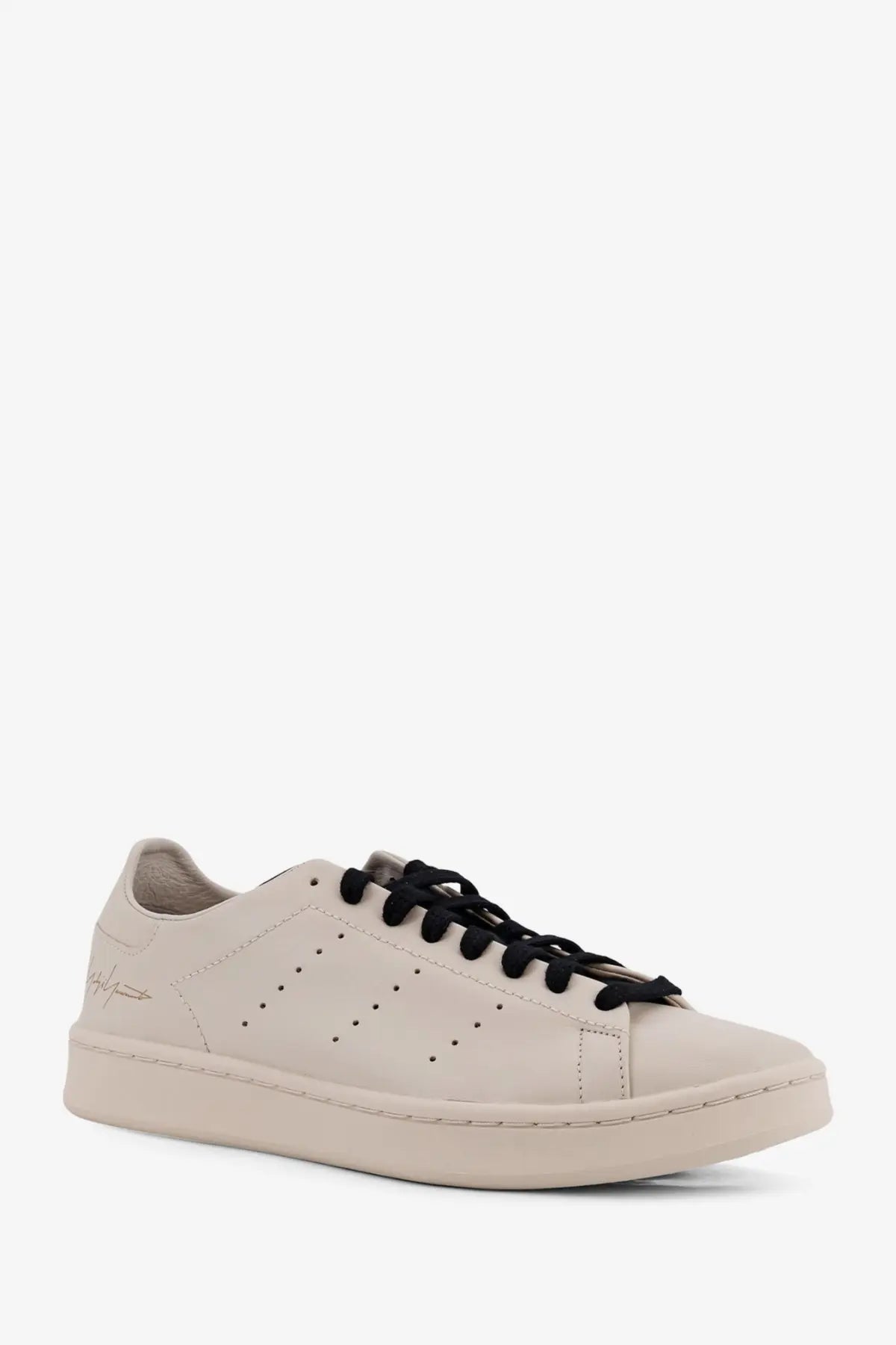 Cream-colored leather low-top y-3 men’s stan smith sneaker with black laces and minimalist design in beige