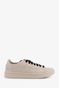 Beige leather low-top y-3 men’s stan smith sneaker with black laces and signature logo on the side