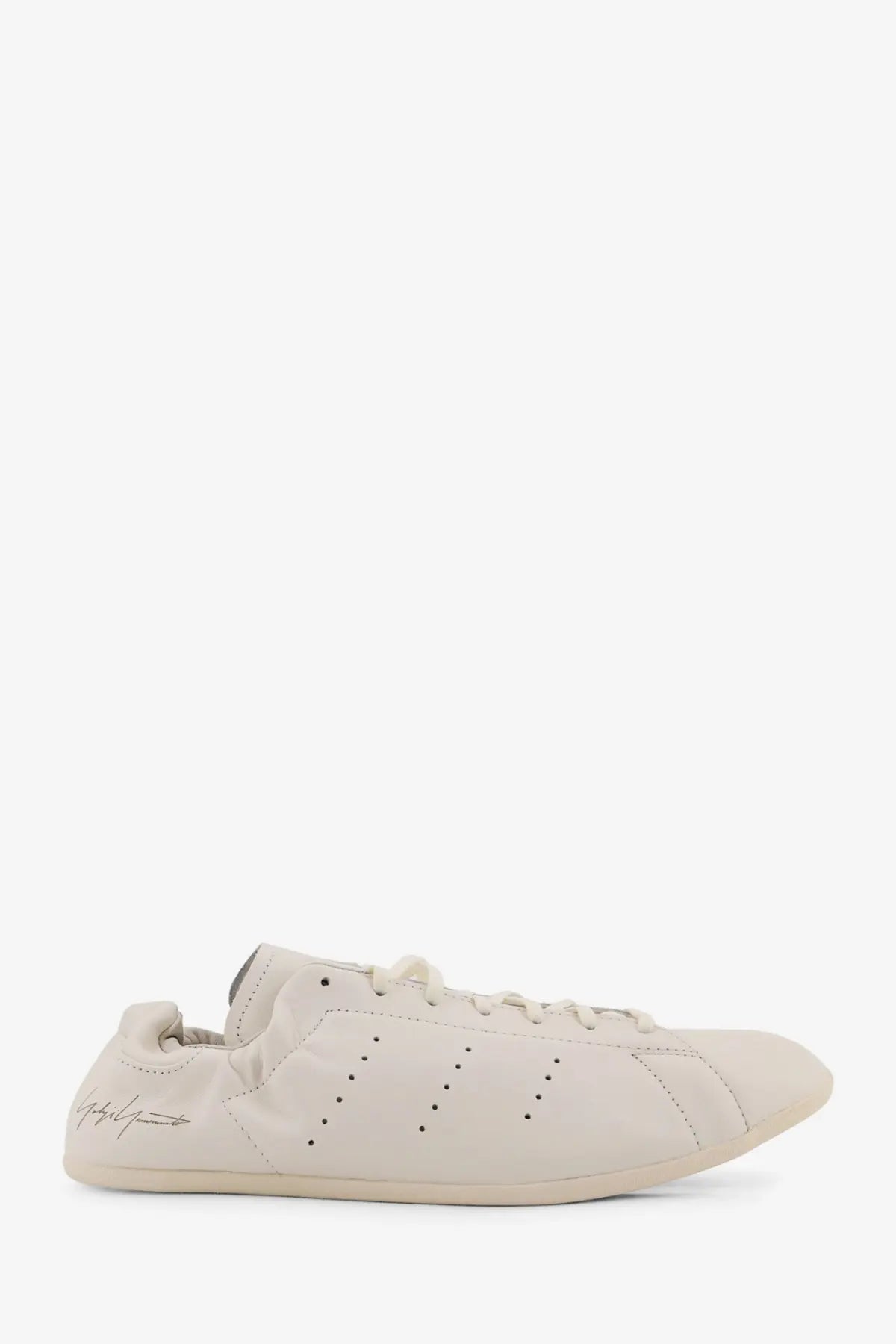 Cream-colored leather y-3 men’s stan smith lo pro sneaker with adidas three stripes and embroidered logo on the side