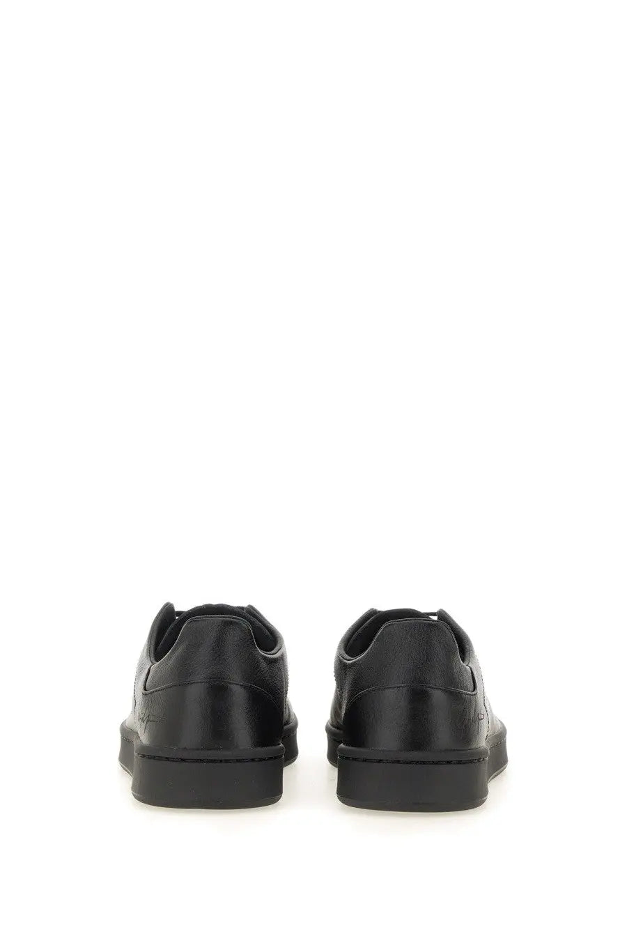Black leather low-top y-3 men’s stan smith sneaker with sleek minimalist design and subtle heel branding back view