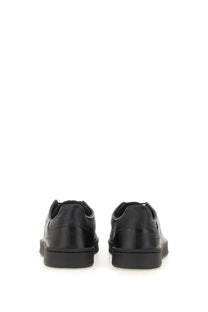 Black leather low-top y-3 men’s stan smith sneaker with sleek minimalist design and subtle heel branding back view