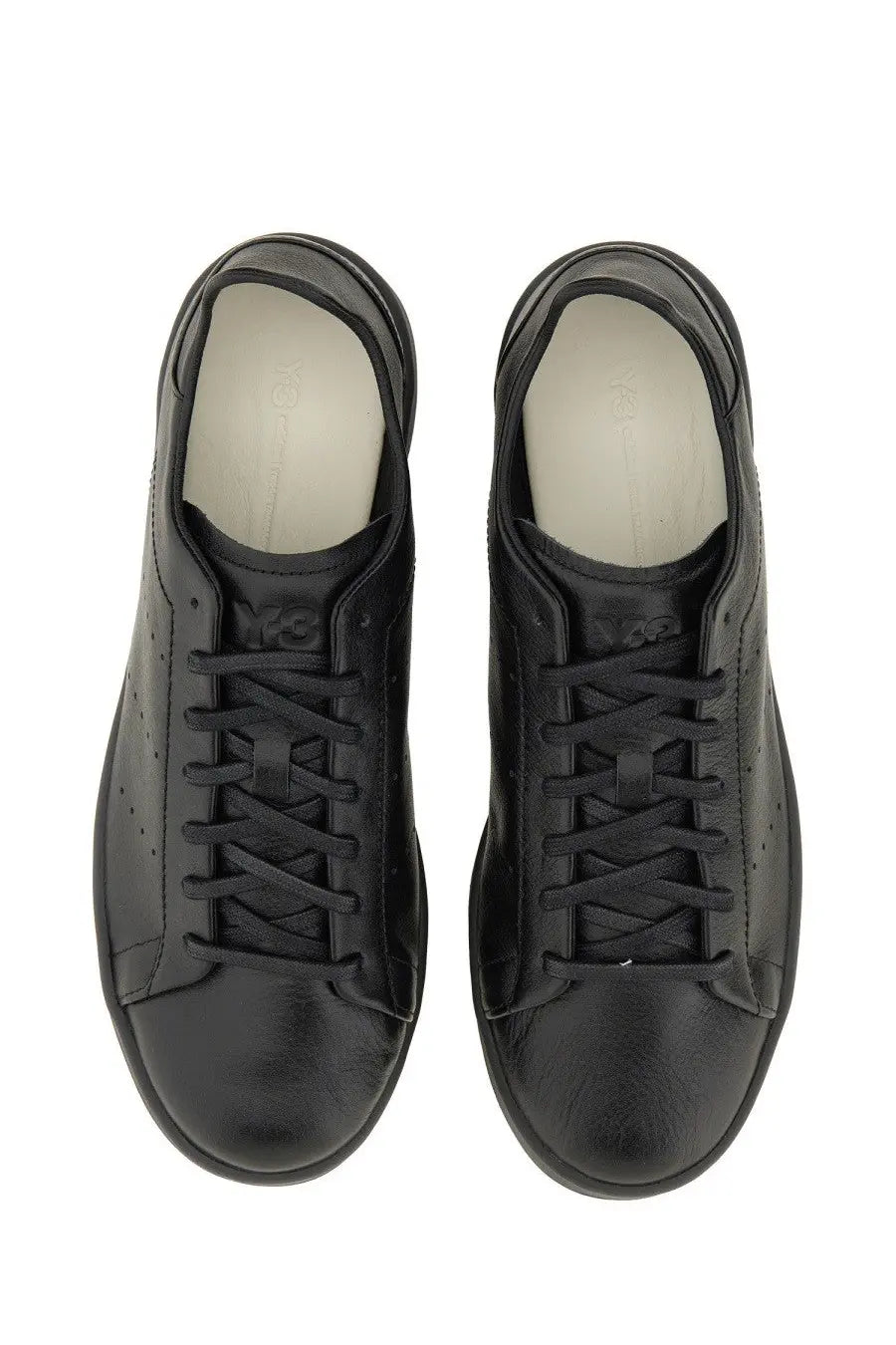 Y-3 men’s stan smith sneaker black in black leather with sleek minimalist design and subtle perforations along the sides