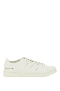 White leather y-3 men’s stan smith low-top sneaker with black branding and perforated detailing in grey