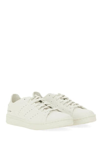 Y-3 men’s stan smith sneaker grey featuring white leather with perforated detailing and minimalist design