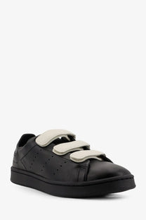 Black leather y-3 men’s stan smith sneaker with three beige velcro straps and perforated detailing in grey