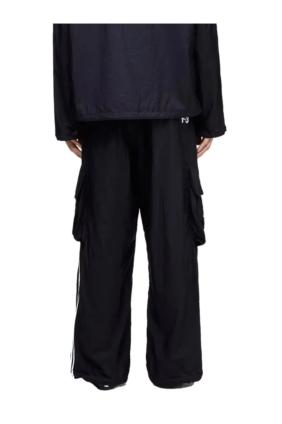 Black y-3 unisex cargo pants with side stripes and multiple pockets designed for functional streetwear style