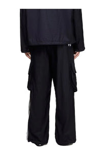 Black y-3 unisex cargo pants with side stripes and multiple pockets designed for functional streetwear style