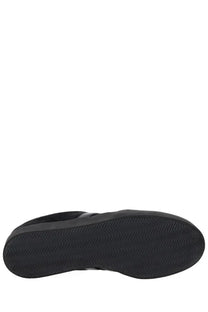 Black rubber sole with wavy tread pattern of y-3 unisex gazelle sneaker in black viewed from the back side