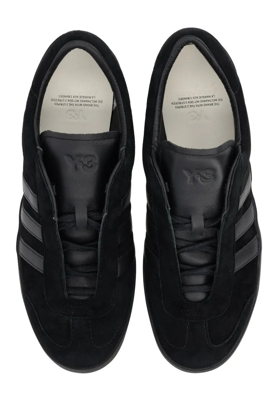 Black suede y-3 unisex gazelle sneaker with three dark gray stripes on the side in a sleek black design