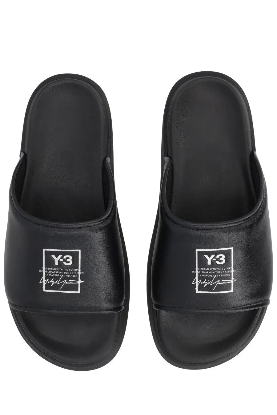 Black y-3 unisex slide sandals with a glossy finish and white logo branding on the footbed