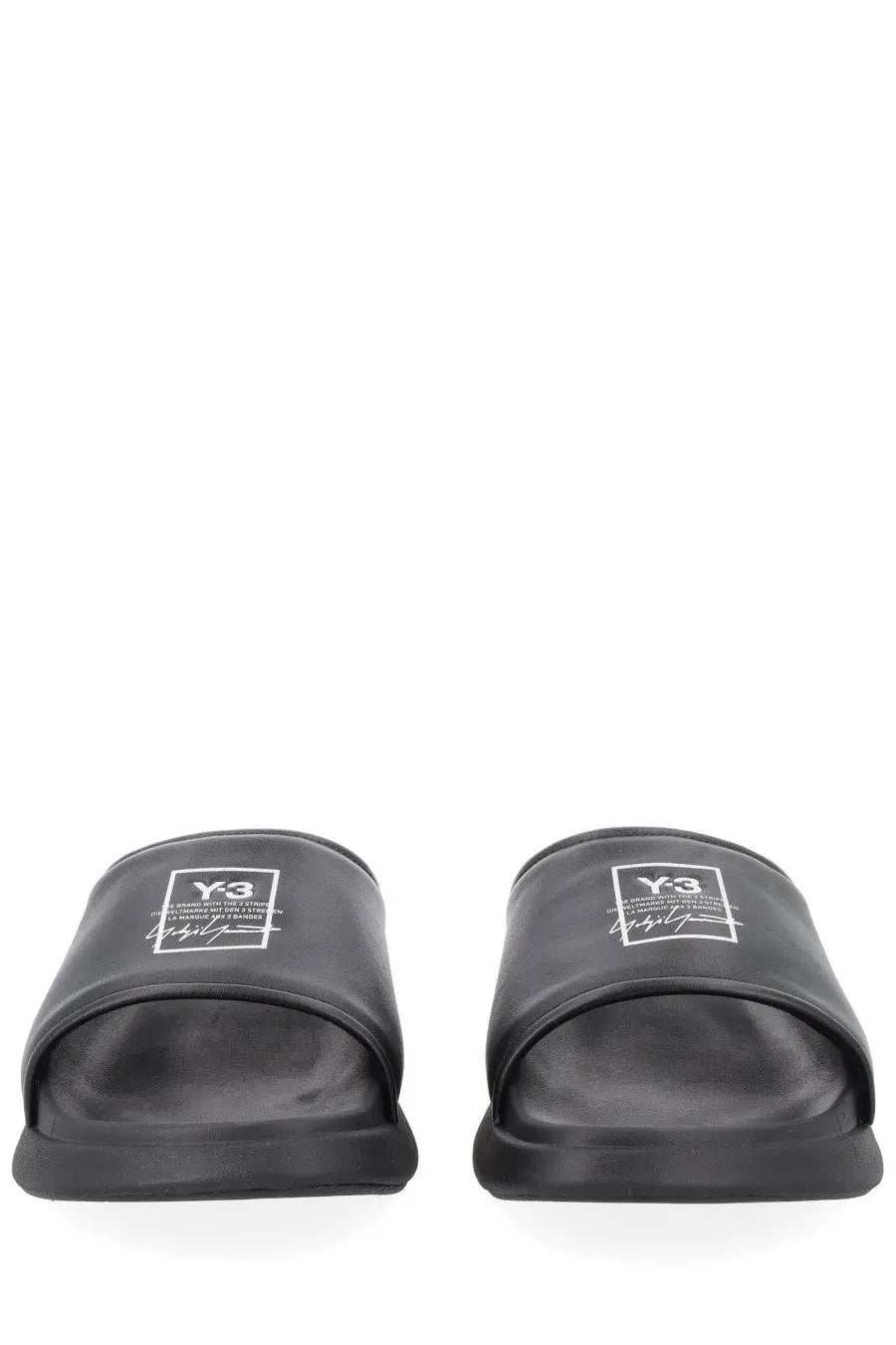 Black y-3 unisex slide sandals with sleek minimalist design and subtle white logo on the footbed