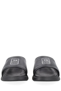 Black y-3 unisex slide sandals with sleek minimalist design and subtle white logo on the footbed