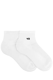 White y-3 unisex ankle socks with a small black logo on the side, made for comfortable everyday wear