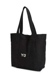 Black canvas y-3 unisex tote bag featuring white embroidered logo on the front for everyday use