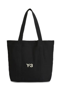 Black y-3 unisex tote bag featuring a white embroidered logo on the front made from durable fabric
