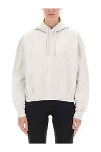 Cream-colored y-3 women’s hooded sweatshirt with subtle embroidered logo and matching drawstrings in soft fabric