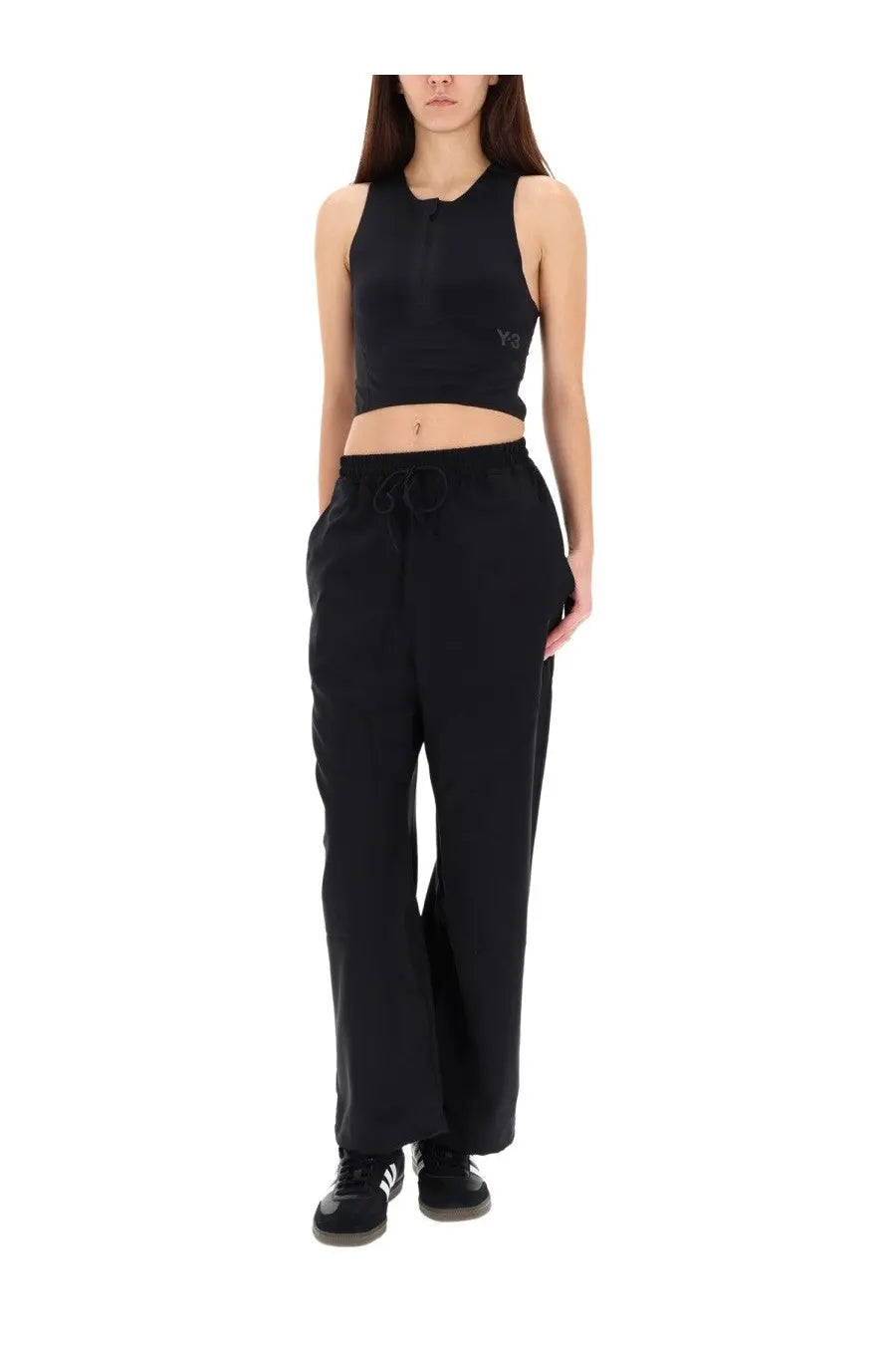 Black y-3 crop top with subtle logo on left chest and elastic waistband paired with women’s black jogging pants