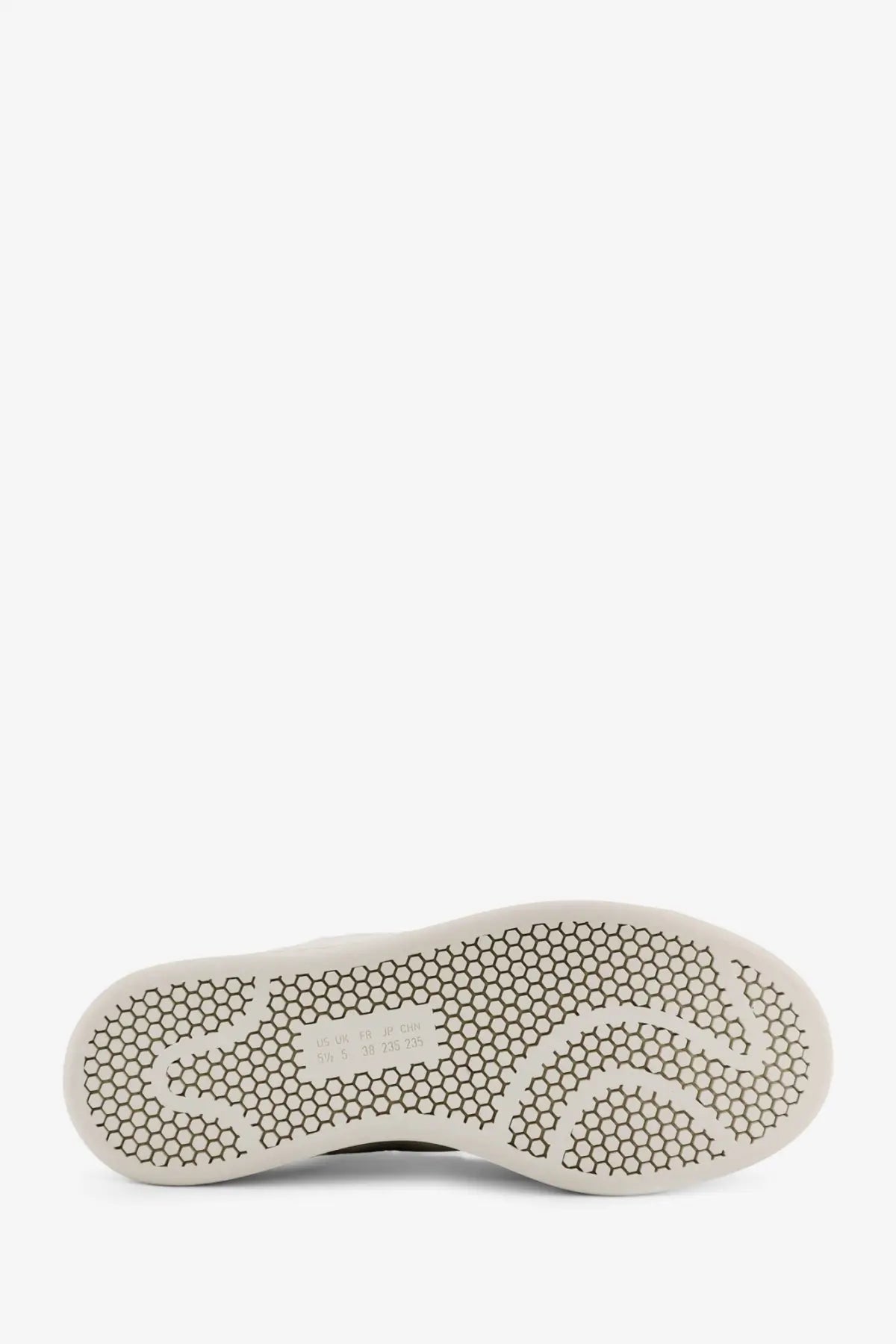 White rubber sole with hexagonal tread and subtle branding on y-3 women’s stan smith velcro leather grey sneakers