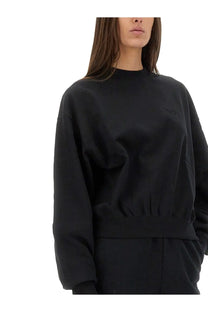 Black oversized Y-3 women’s crewneck sweatshirt with elastic waistband and subtle embroidered logo on chest