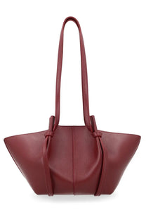 A sleek burgundy leather tote bag with a soft silhouette and knotted dual top handles by yuzefi women