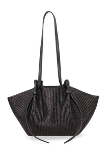 Black woven raffia tote bag with leather straps and drawstring closure by Yuzefi for women