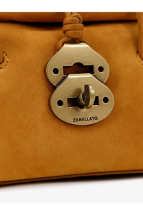 A brass-colored oval padlock with keyhole and zanellato engraving on zanellato women’s dotta baby suede crossbody bag yellow