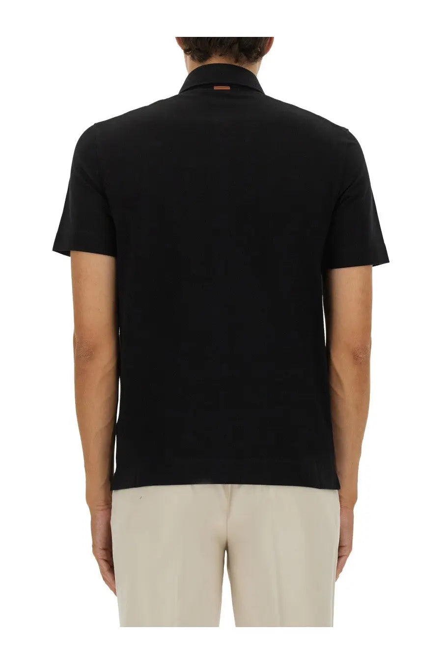 Zegna men’s black cotton polo shirt with ribbed collar and subtle orange brand tag at the back of the neck