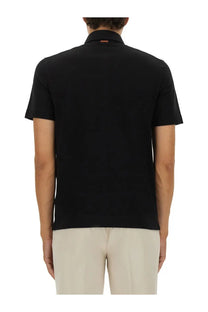 Zegna men’s black cotton polo shirt with ribbed collar and subtle orange brand tag at the back of the neck