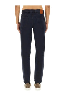 Dark blue denim jeans with brown leather patch at waistband shown from back in zegna men’s denim pants black
