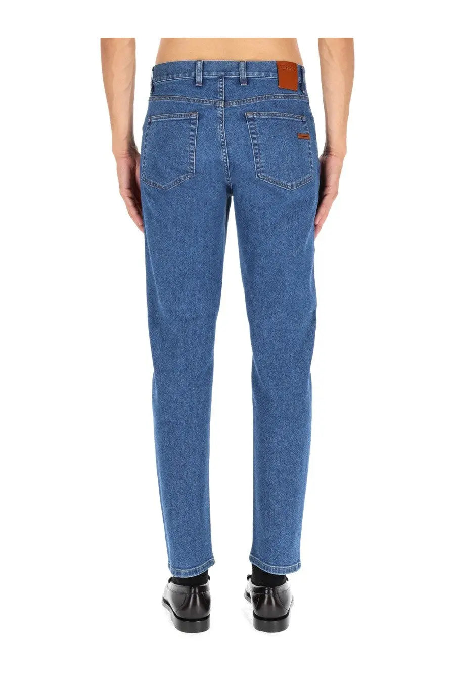 Zegna men’s jeans Roccia blue with classic straight-leg cut blue denim and brown leather brand patches on waistband back view