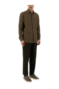 Olive green linen button-down shirt with classic collar and subtle texture paired with zegna men’s brown pants
