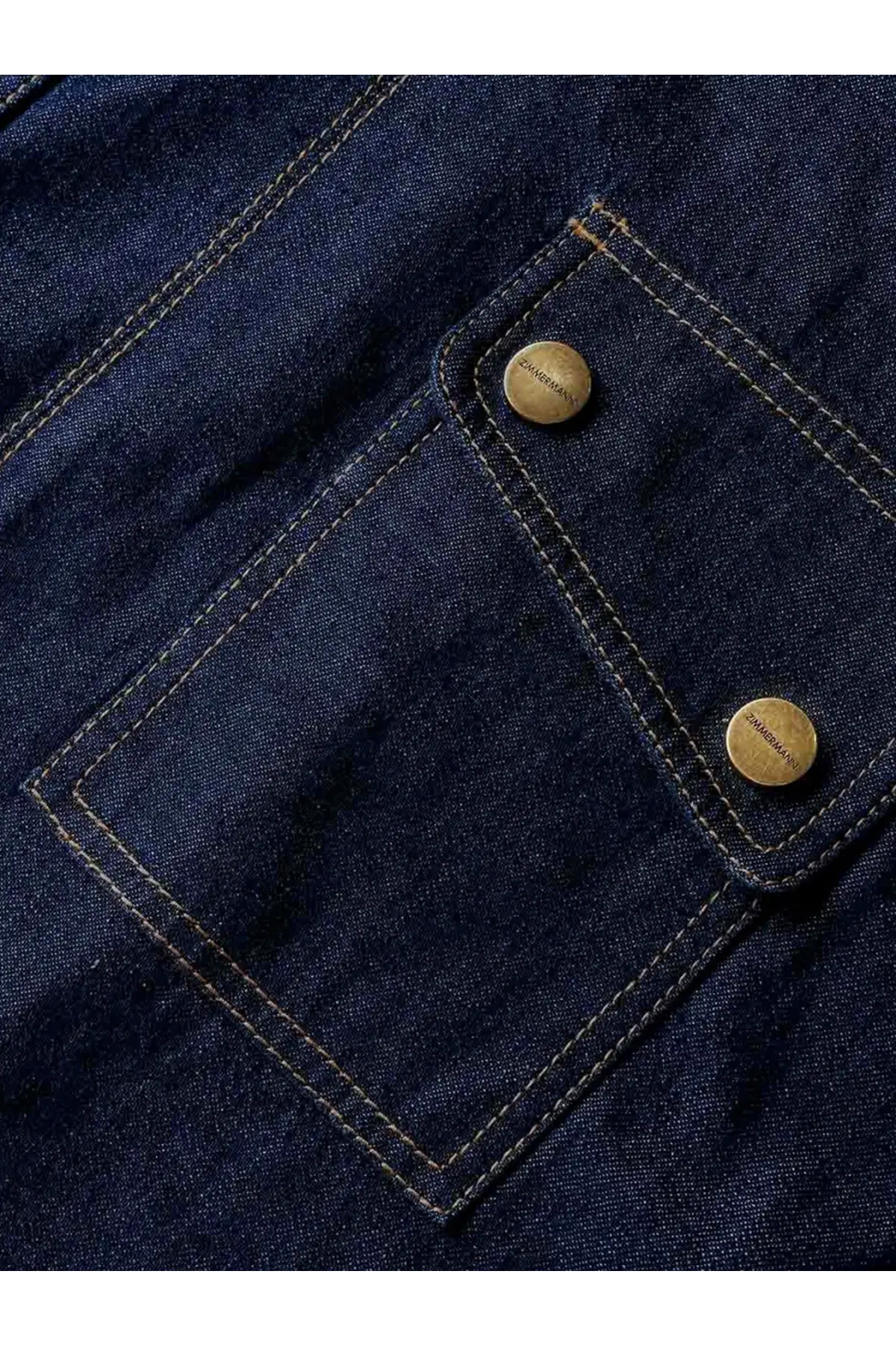 Zimmermann women’s cargo denim shirt blue featuring a dark blue denim pocket with brass buttons and contrasting stitching