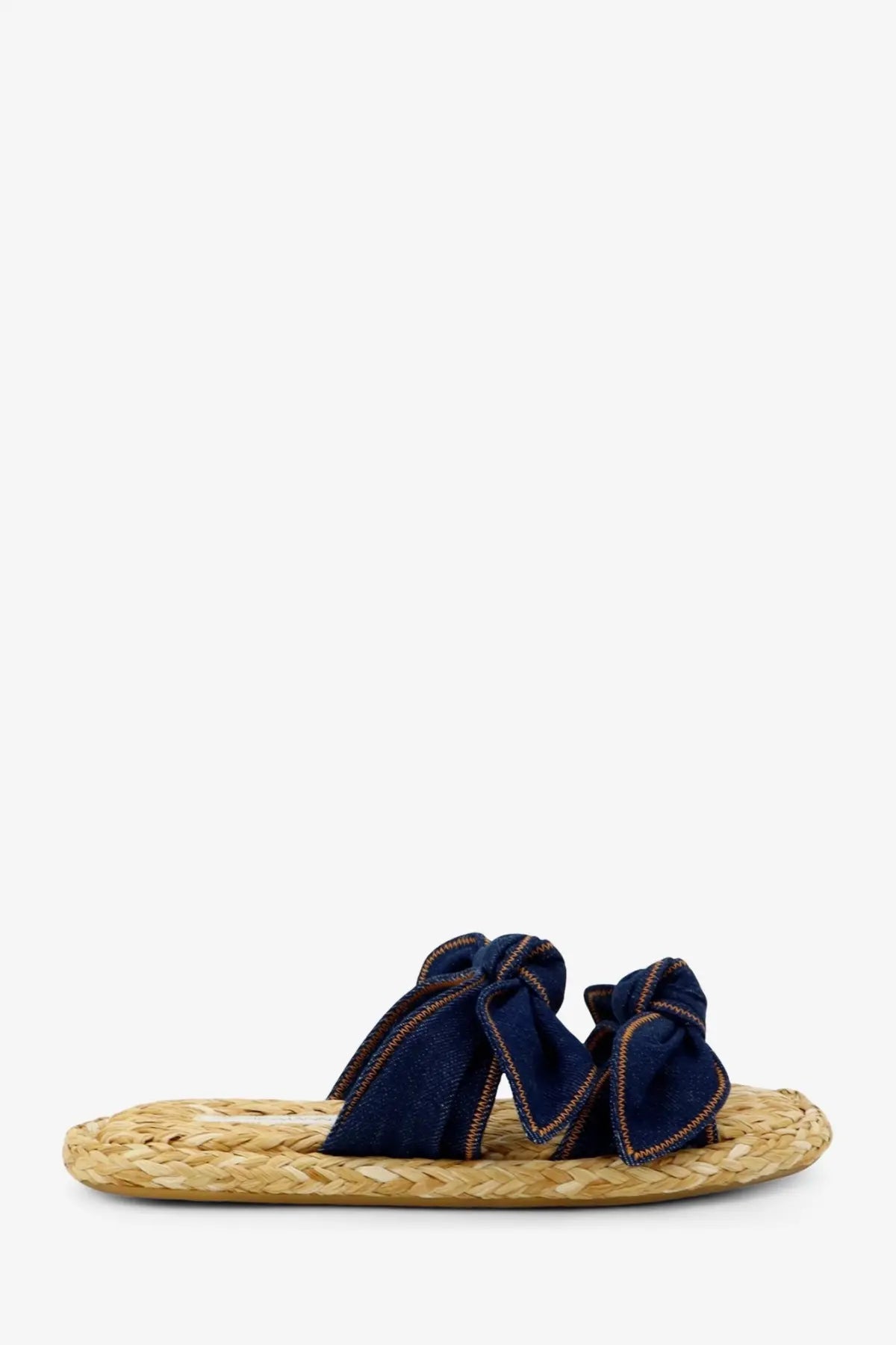 Navy blue denim bow slide sandal with woven straw sole Zimmermann women’s Carousel raffia and denim sandals blue
