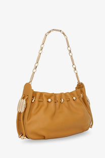 Tan leather shoulder bag with gold-tone chain strap and decorative metal accents from Zimmermann women’s collection