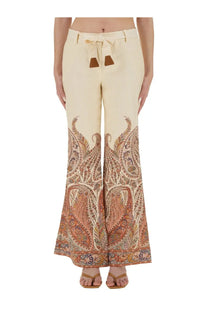 Zimmermann women’s cream-colored wide-leg pants with intricate paisley pattern tied waistband and brown leather accents
