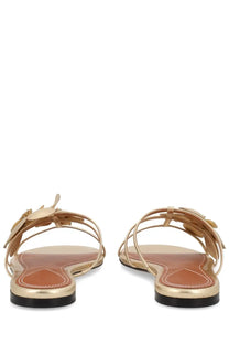 Zimmermann women’s gold-toned leather sandals with delicate floral embellishments and a sleek minimalist design