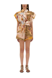 A woman wears Zimmermann women’s multicolor short overalls with tropical print, puff sleeves, and a belted waist