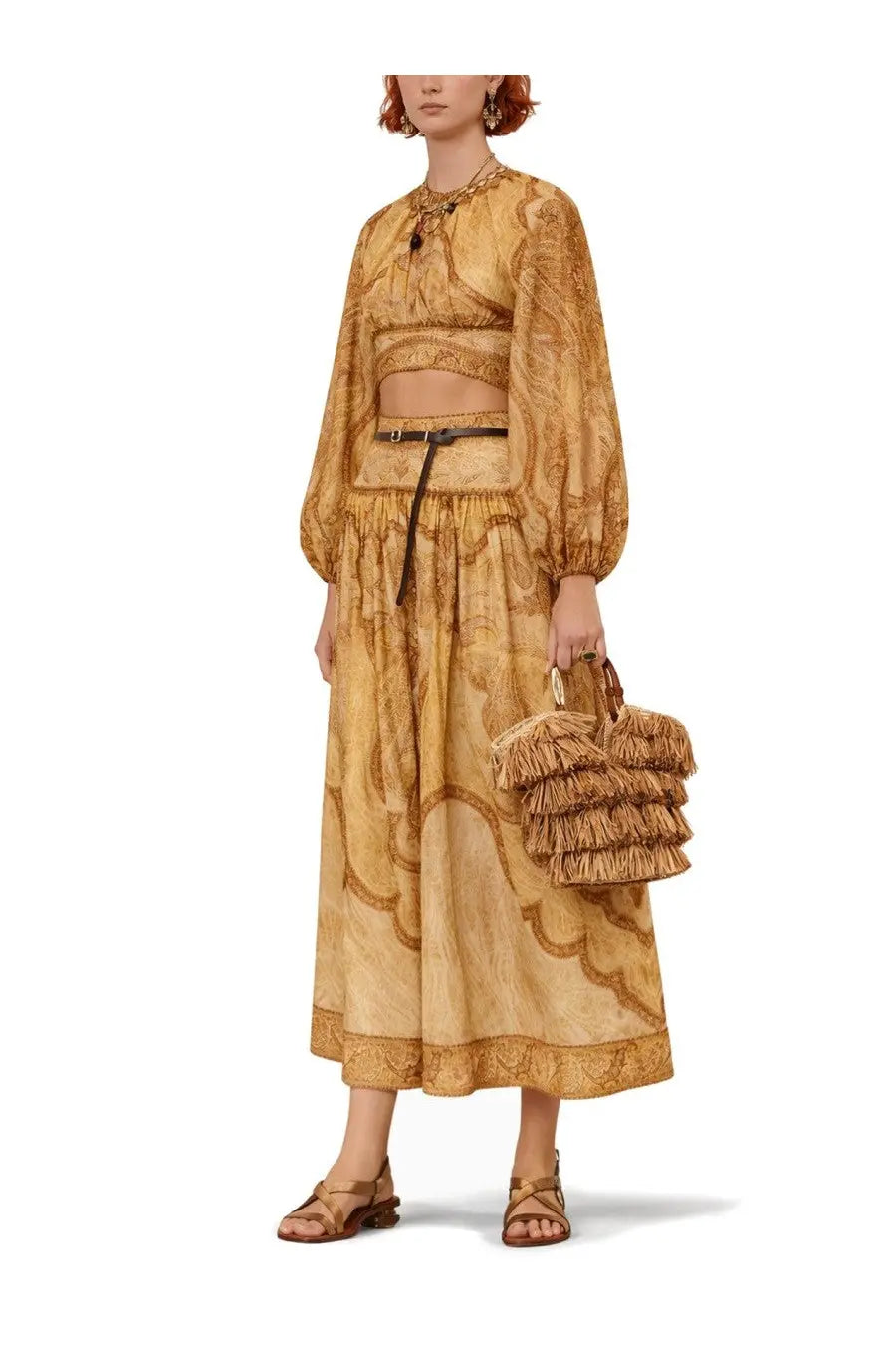A woven straw handbag with tiered fringed detailing and natural texture paired with zimmermann womens wanderlust bodice multicolor