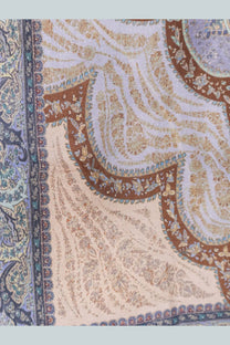 A luxurious cream silk scarf with intricate paisley pattern in gold brown and teal complements zimmermann blue tunic dress